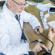 serious-doctor-measuring-blood-pressure-patient